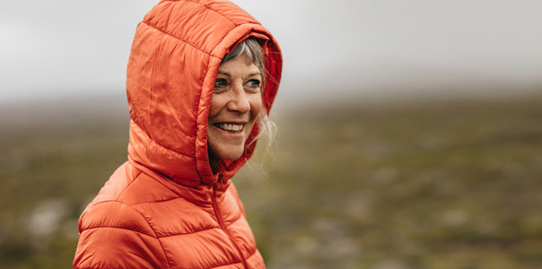 Close up of a senior woman in a hooded jacket