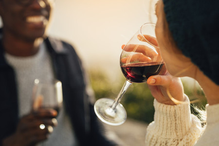 Woman drinking wine on picnic with boyfriend