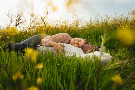 Romantic couple lying in the flowering meadow