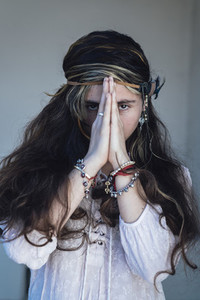 Ethic woman clasping hands and praying