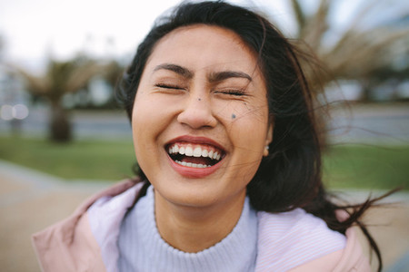 Close up of an asian woman laughing