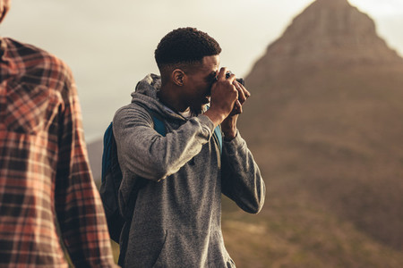 Man taking pictures during a hike with friends