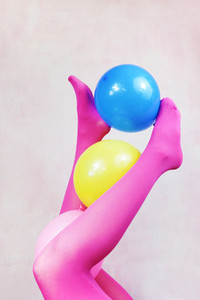 Pop art about legs wearing pink tights and holding balloons