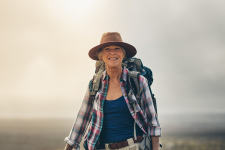 Portrait of a cheerful senior woman in hat