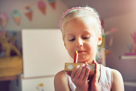 Little kid holding slice of toy cake