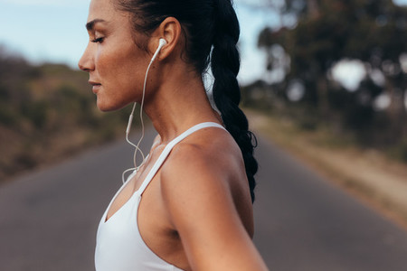 Female runner listening to music