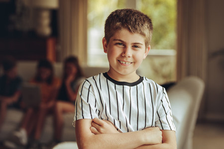 Kid standing at home with arms crossed