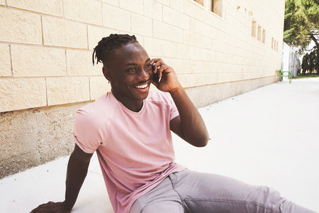Young and very happy man talking by his phone