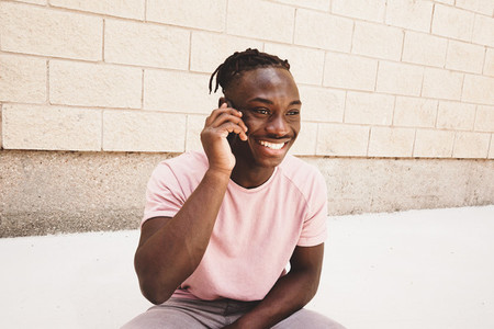 Young and very happy man talking by his phone