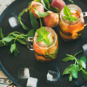 Summer refreshing cold peach ice tea in jars  square crop