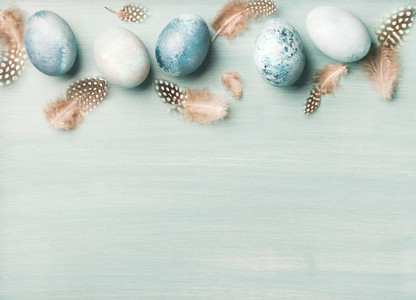 Painted traditional eggs for Easter holiday over light blue background
