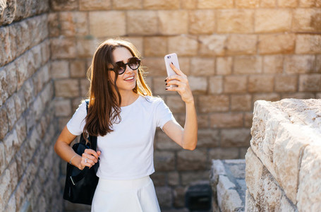 Happy young woman taking selfie