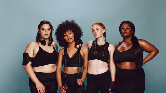 Group of women with different weights in sportswear