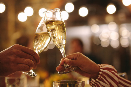 Couple toasting champagne glasses at party