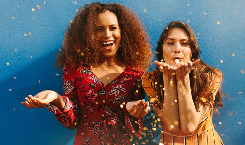 Women friends having fun with glitters
