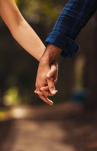 Couple holding hands on a walk in the park