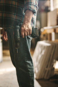 Carpenter with a hand drill machine