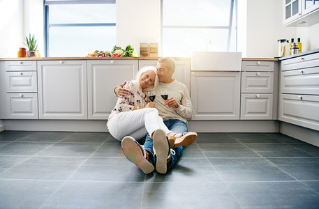 Senior couple enjoying a loving moment together in their kitchen