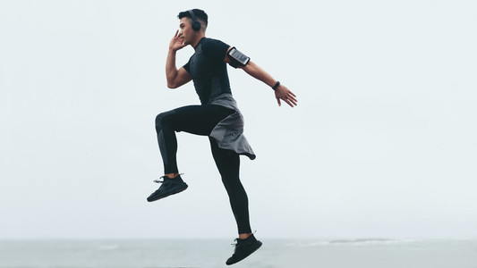 Sporty man exercising jump and lunge