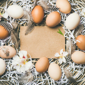 Natural colored eggs for Easter in basket square crop