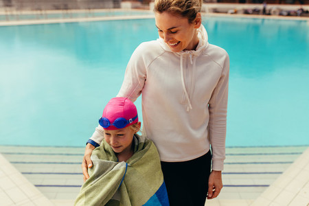 Girl with coach at swimming pool