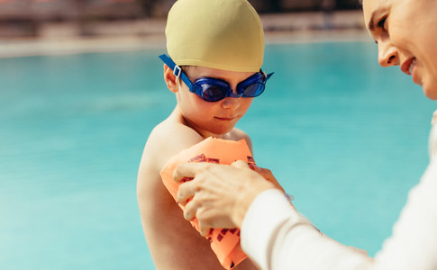Boy getting ready for swimming lessons at pool