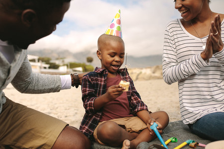 Couple celebrating birthday of their son at the beach