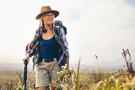 Cheerful senior woman enjoying her hiking trip