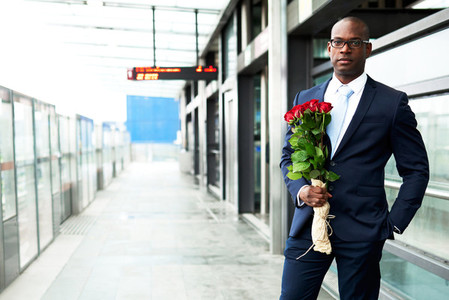 Businessman at Metro Holding Bouquet of Flowers