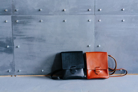 two leather bags on a gray background
