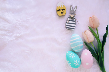 Happy Easter concept with wooden bunny and colorful easter eggs
