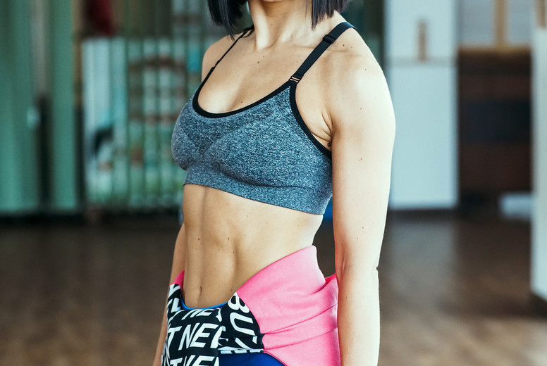 Athletic woman doing exercises in the gym