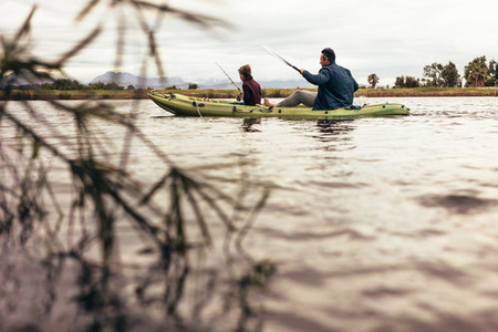 Father and son out for fishing in a kayak