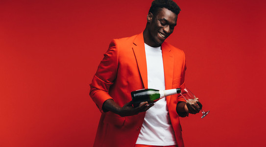 Handsome african guy having champagne