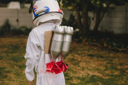 Boy dressed as astronaut with a toy jetpack