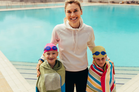Kids with coach at swimming pool