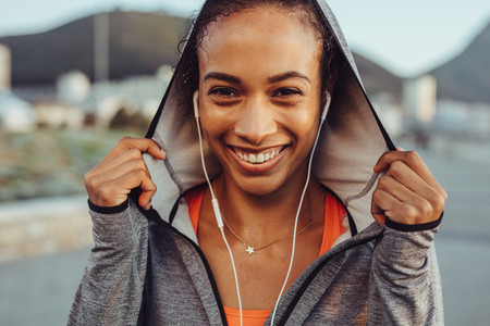 Confident fitness woman in a hoodie