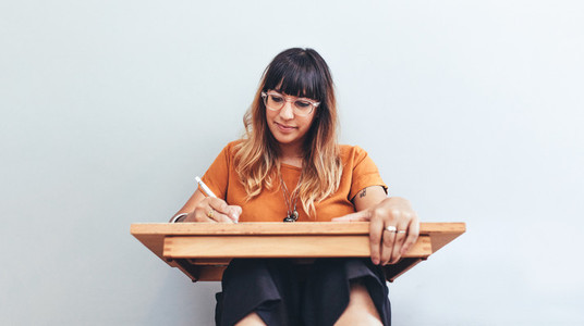 Close up of an illustrator working on her drawings
