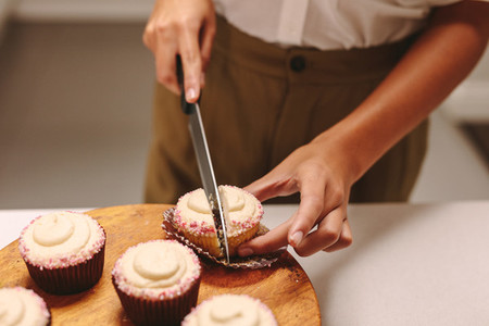 Chef cutting a cupcake