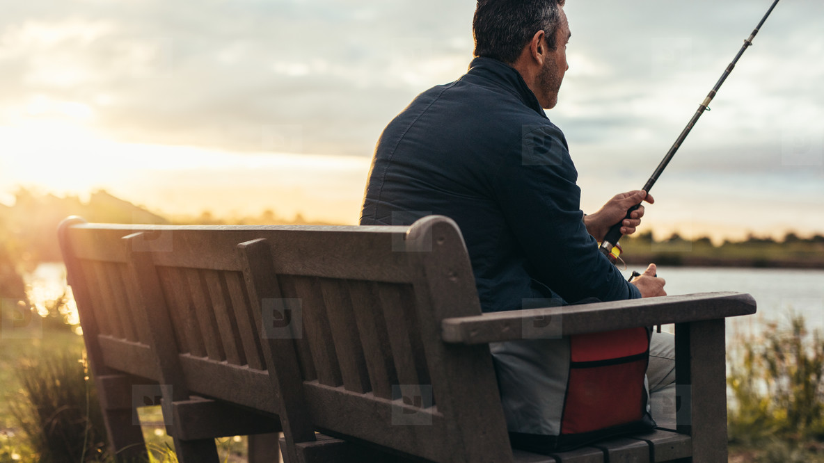 Rear view of a man fishing