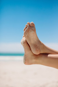 Feet in a relaxed position at the beach