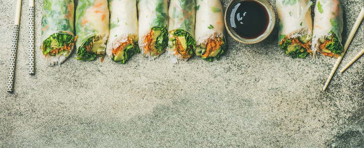 Flat lay of vegan spring  summer rice paper rolls  wide composition