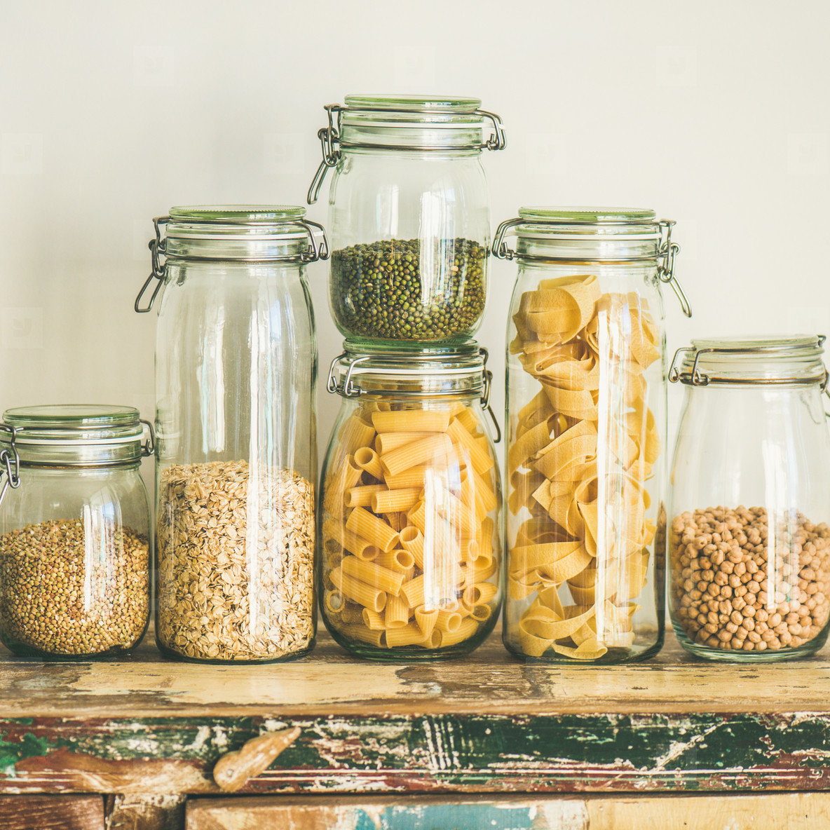 Uncooked cereals  grains  beans and pasta on table  square crop