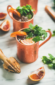 Blood orange Moscow mule alcohol cocktails in mugs