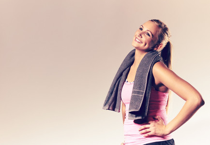 Woman wearing workout clothes posing with head tilted back