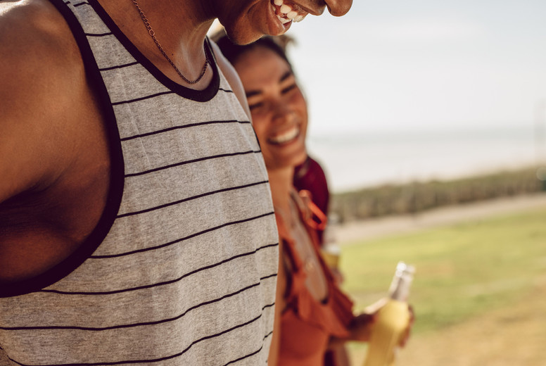 Friends having beers while walking to the picnic spot