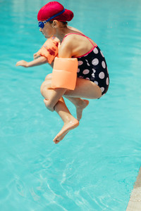 Girl jumping into the swimming pool