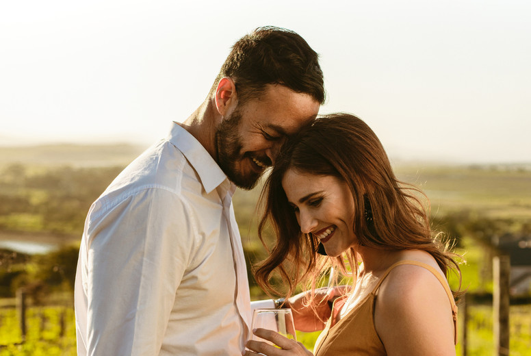 Romantic couple standing together in a vineyard