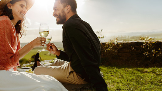 Couple on a date near a wine farm drinking wine