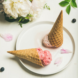 Ice cream scoops and peonies over white background square crop